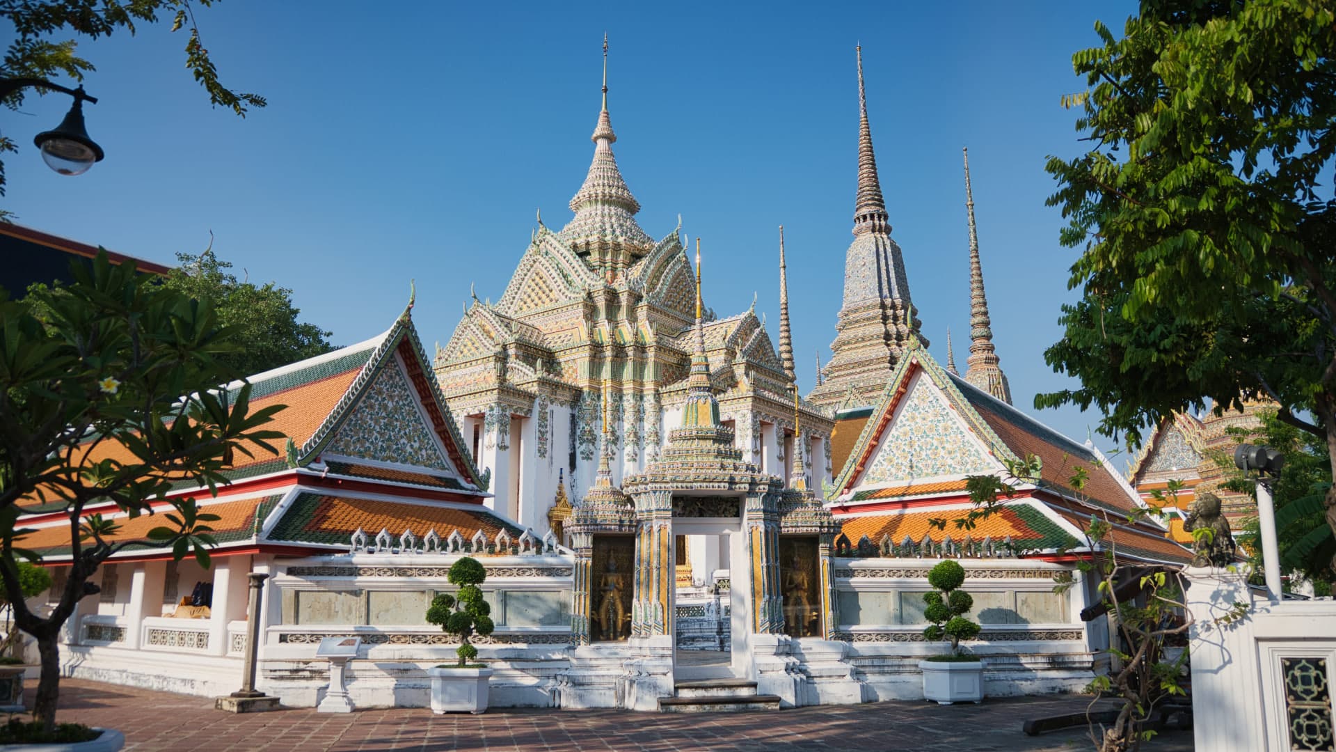 The ordination hall and spires of Wat Pho under a clear sky